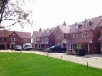 Professional roofer working safely on a residential roof in Barnet
